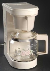 a coffee maker with a flower on it